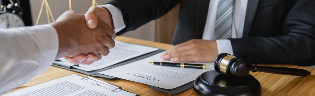 Lawyers shake hands with business people to seal a deal with partner lawyers. or a lawyer discussing